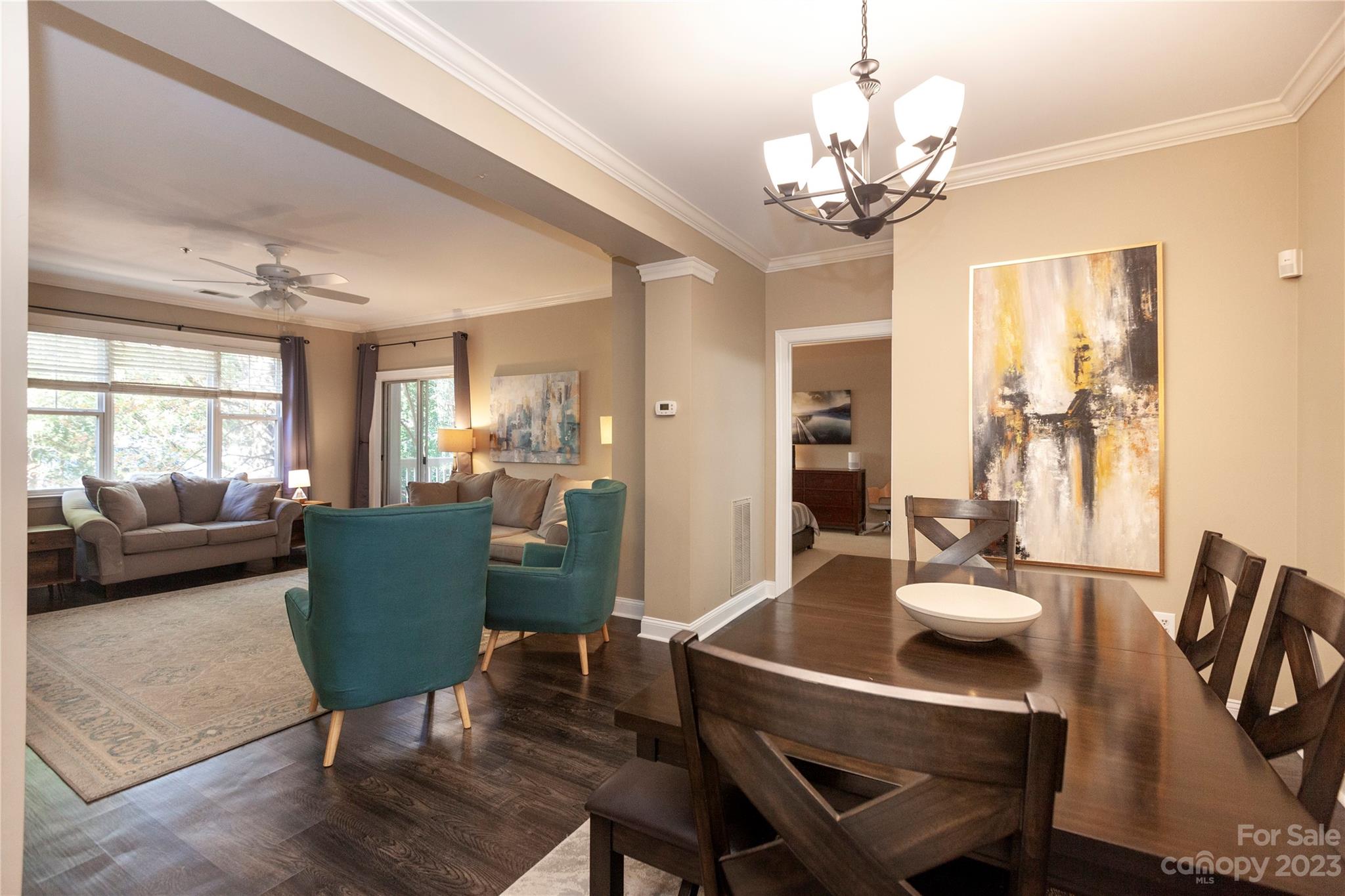 5601 Fairview Road, Unit 19 Charlotte, NC 28209 - Photo 3 of 30 a view of a dining room with furniture a chandelier and wooden floor