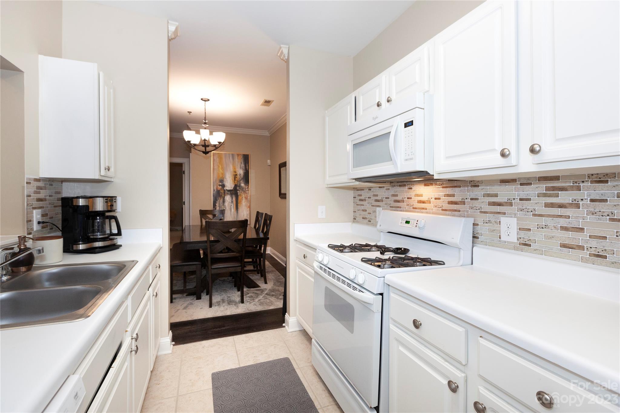 5601 Fairview Road, Unit 19 Charlotte, NC 28209 - Photo 10 of 30 a kitchen with granite countertop a sink stove and cabinets