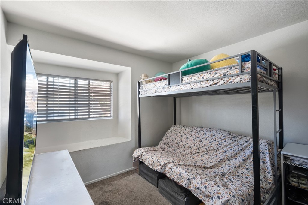 11840 Rustic Place Fontana, CA 92337 - Photo 13 of 20 a bedroom with a bed and a window