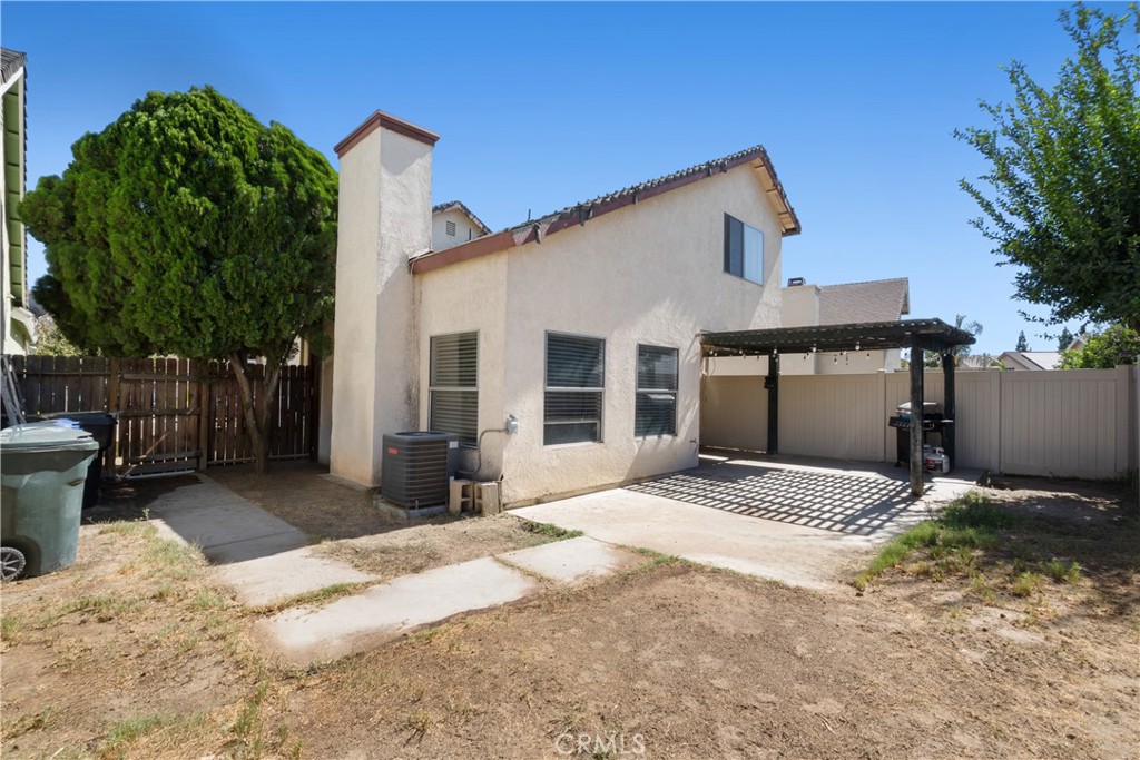 11840 Rustic Place Fontana, CA 92337 - Photo 14 of 20 a front view of a house with a yard and garage