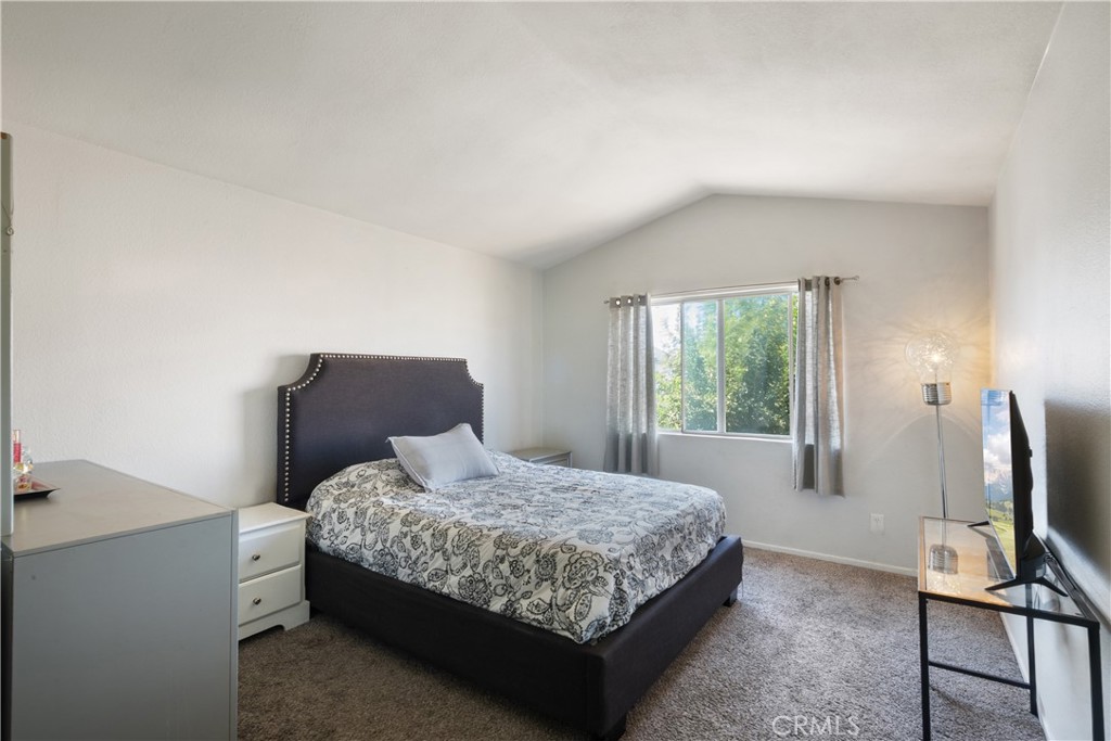 11840 Rustic Place Fontana, CA 92337 - Photo 8 of 20 a bedroom with a bed flat screen tv and window