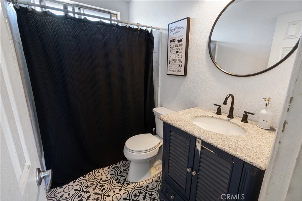 11840 Rustic Place Fontana, CA 92337 - Photo 10 of 20 a bathroom with a sink and a mirror