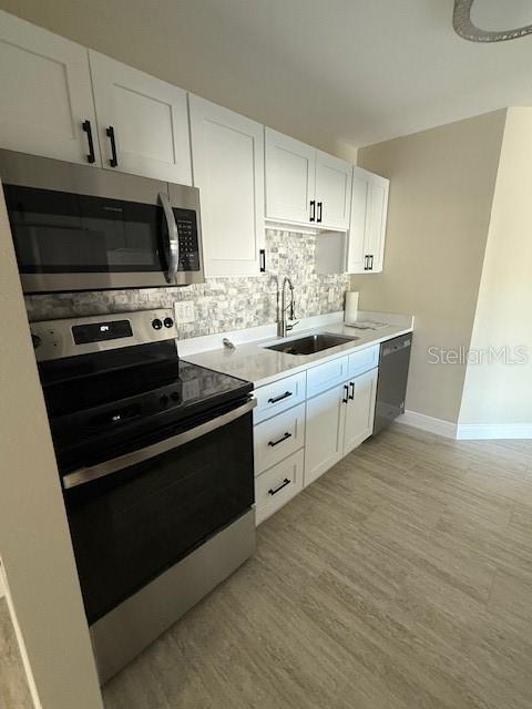 a kitchen with stainless steel appliances a stove a sink and a microwave