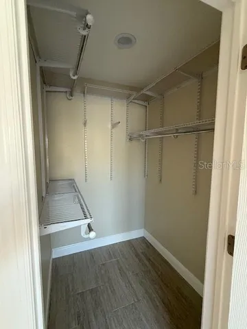 a view of a room with wooden floor