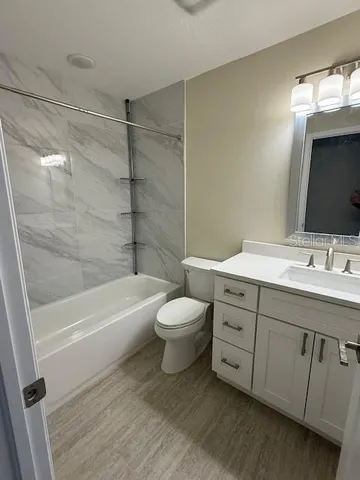 a bathroom with a double vanity sink toilet and shower
