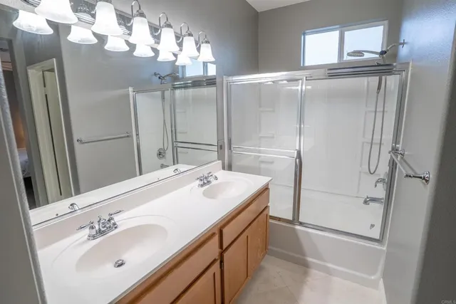 a bathroom with a sink a mirror and a shower