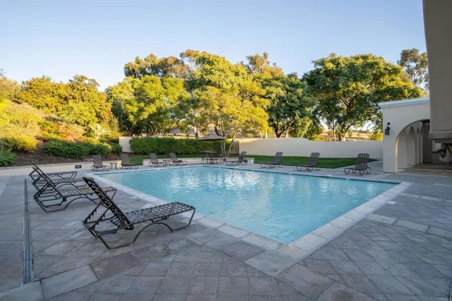 a view of swimming pool with outdoor seating and plants