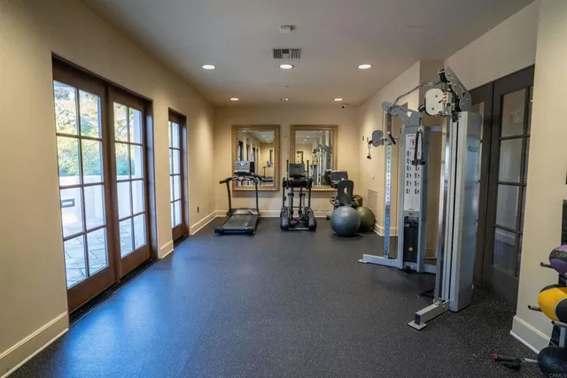 a view of a room with gym equipment and a large window