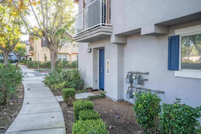 a front view of a house with a yard and fountain in middle
