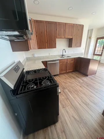 a kitchen with wooden cabinets and a stove top oven