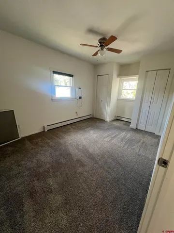 an empty room with a empty space and windows