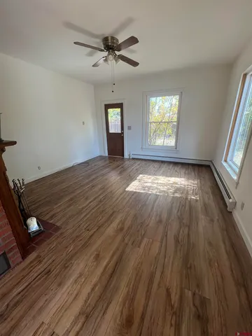wooden floor in an empty room with a window