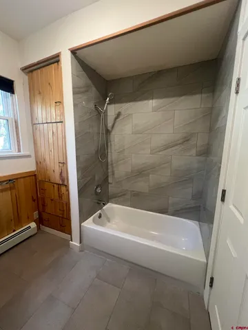 a bathroom with a bathtub and a shower