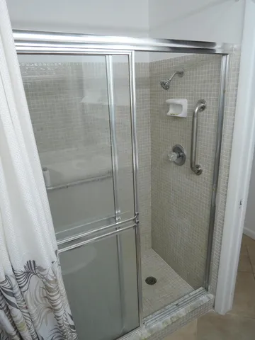 a bathroom with a glass shower door