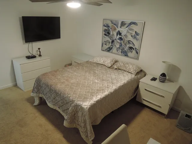 a bedroom with a bed and a flat screen tv