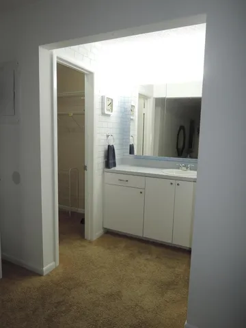 a view of a bathroom with a sink and mirror