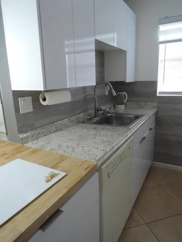 a kitchen with sink and window