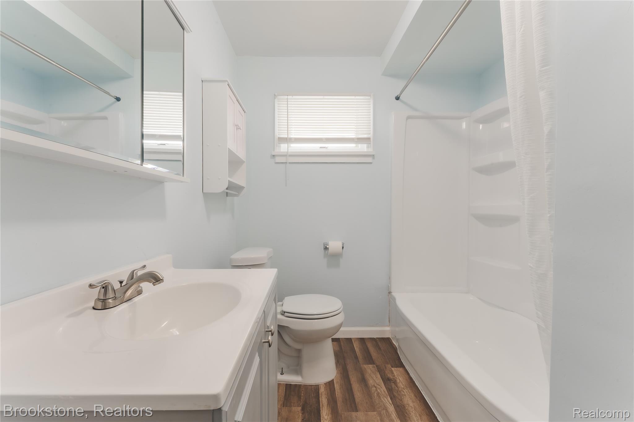 202 West Rundell Street Pontiac, MI 48342 - Photo 18 of 27 Full bath with vanity, shower / tub combination, and dark wood-type flooring