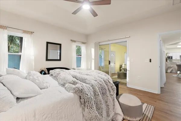 a bedroom with a bed and wooden floor