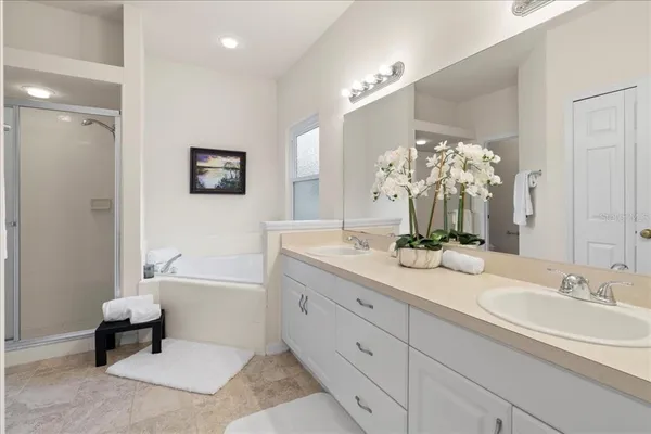 a bathroom with a double vanity sink and a mirror
