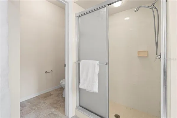 a bathroom with a granite countertop shower