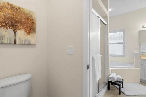 a bathroom with a toilet and a shower