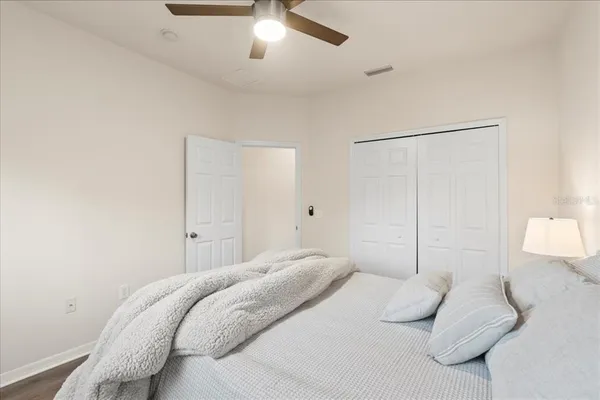 a bedroom with a bed and a lamp