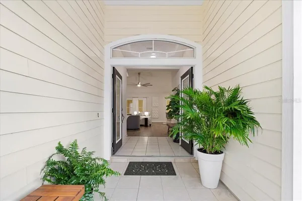 a view of a entryway door with potted plants in front of door