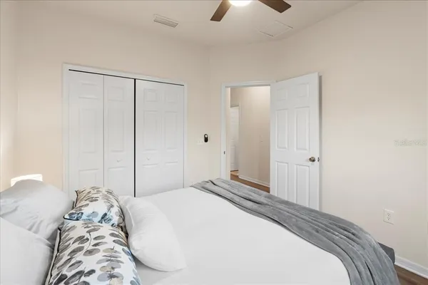 a bedroom with a bed and a chandelier