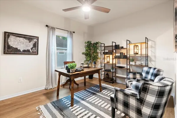 a living room with furniture and a bookshelf