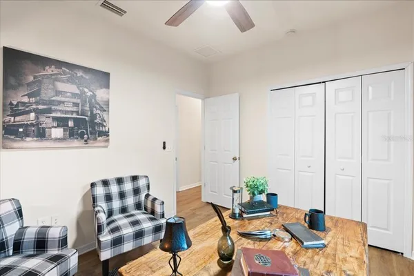 a living room with furniture and wooden floor