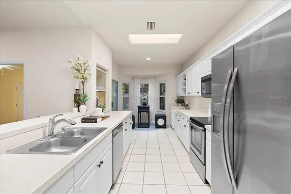 a kitchen with stainless steel appliances a sink stove and refrigerator