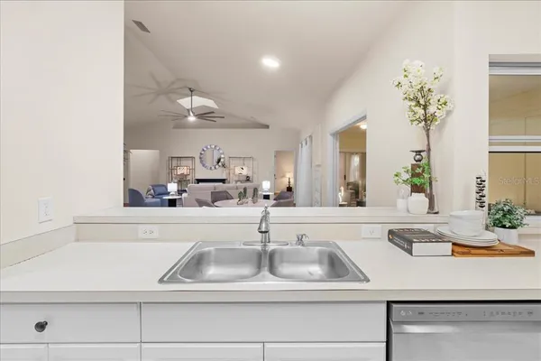 a kitchen with a sink and a mirror