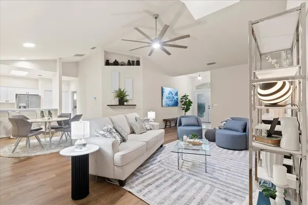 a living room with furniture and view of kitchen