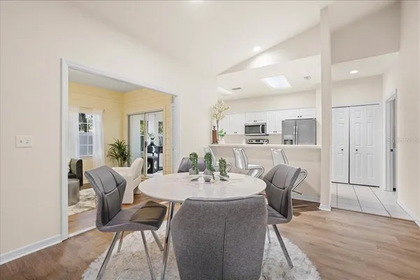 a view of a dining room with furniture and wooden floor