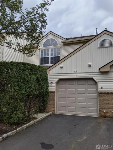 a front view of a house with garage