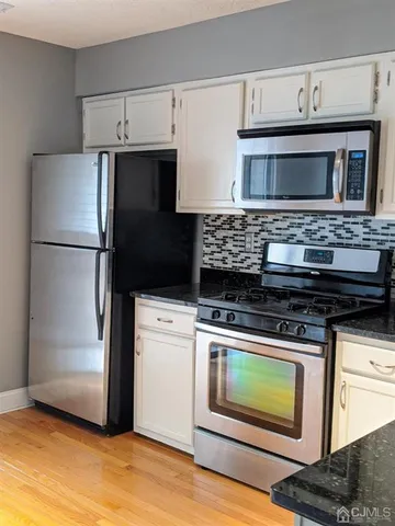 a kitchen with a stove and a refrigerator