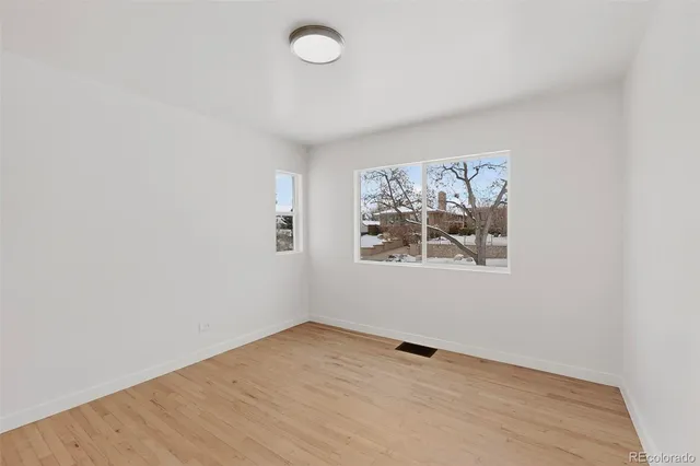 wooden floor in an empty room with a window