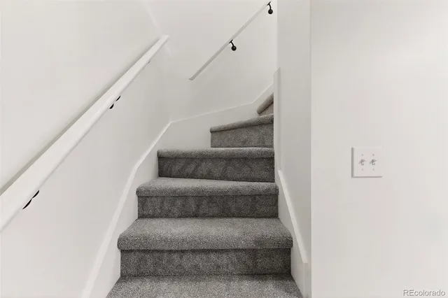 a bathroom with a sink vanity mirror and toilet