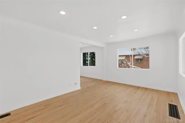a kitchen with stainless steel appliances granite countertop a sink a stove and a refrigerator