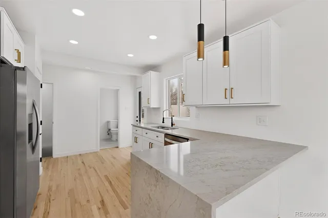 a kitchen with stainless steel appliances a refrigerator and a stove top oven
