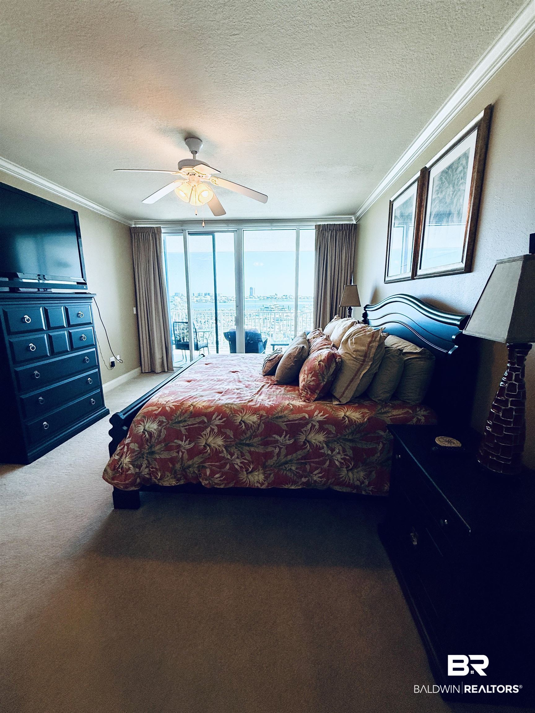 27800 Canal Road, Unit 409 Orange Beach, AL 36561 - Photo 16 of 22 Carpeted bedroom with a textured ceiling, access to exterior, crown molding, expansive windows, and a ceiling fan