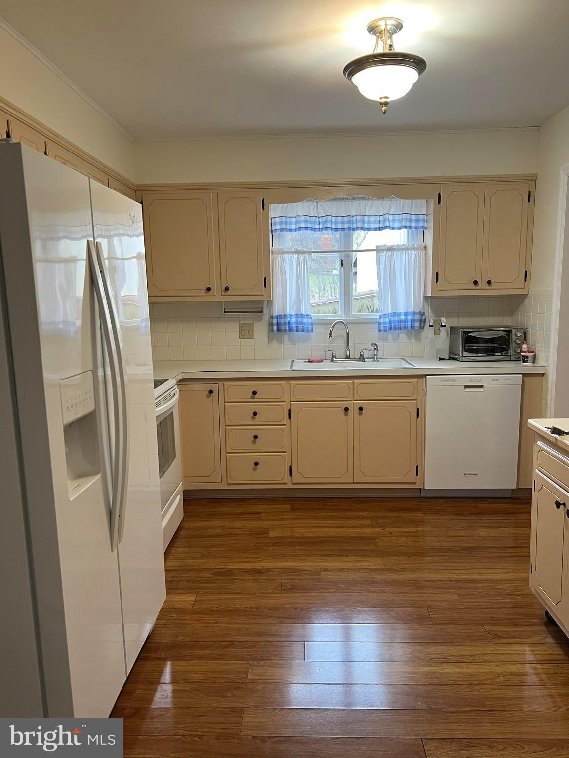 656 Snyder Avenue Beaver Springs, PA 17812 - Photo 10 of 39 a kitchen with stainless steel appliances granite countertop a refrigerator a sink and white cabinets