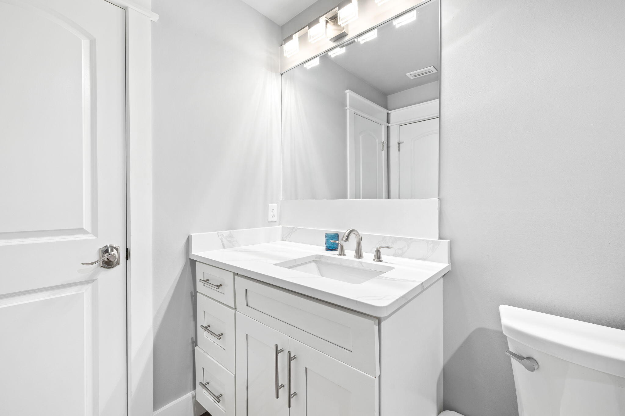 135 Redbud Ln Inlet Beach Inlet Beach, FL 32461 - Photo 42 of 66 a bathroom with a sink a toilet a mirror and vanity