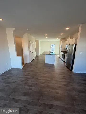 a kitchen with kitchen island a sink appliances and cabinets