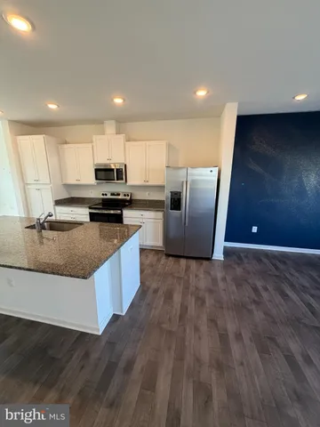 a bathroom with a sink mirror vanity and toilet