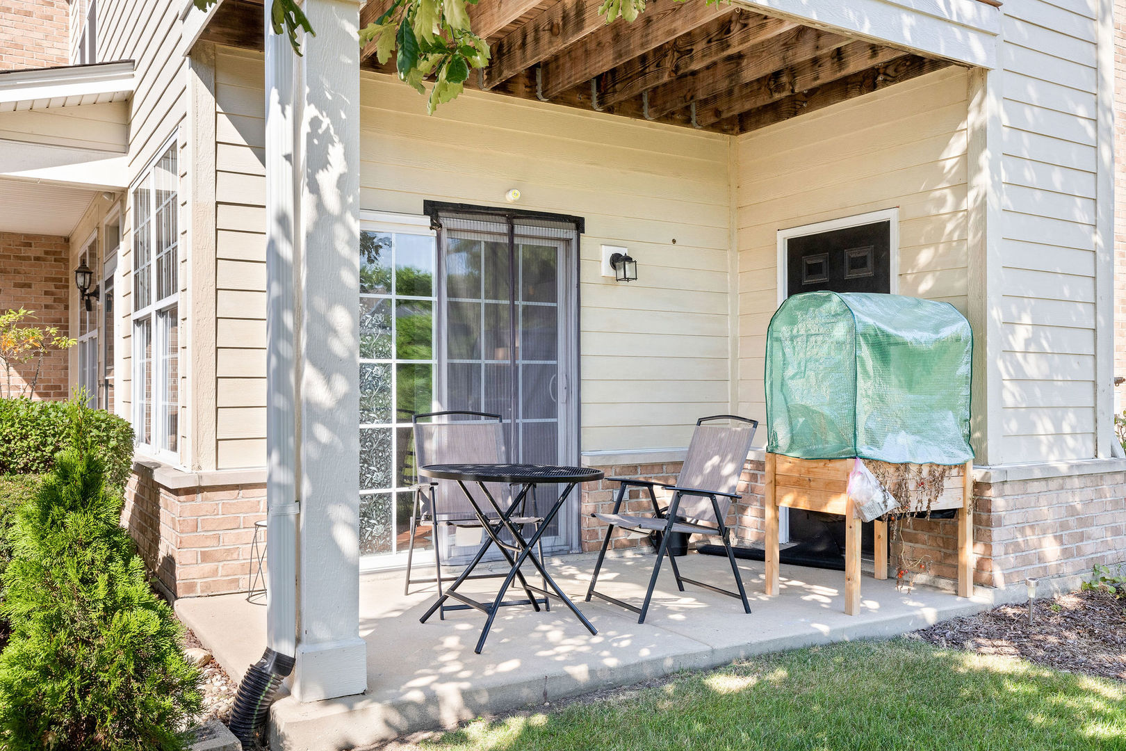 4486 Timber Ridge Court, Unit 4486 Joliet, IL 60431 - Photo 20 of 22 a building outdoor space with patio furniture and potted plants