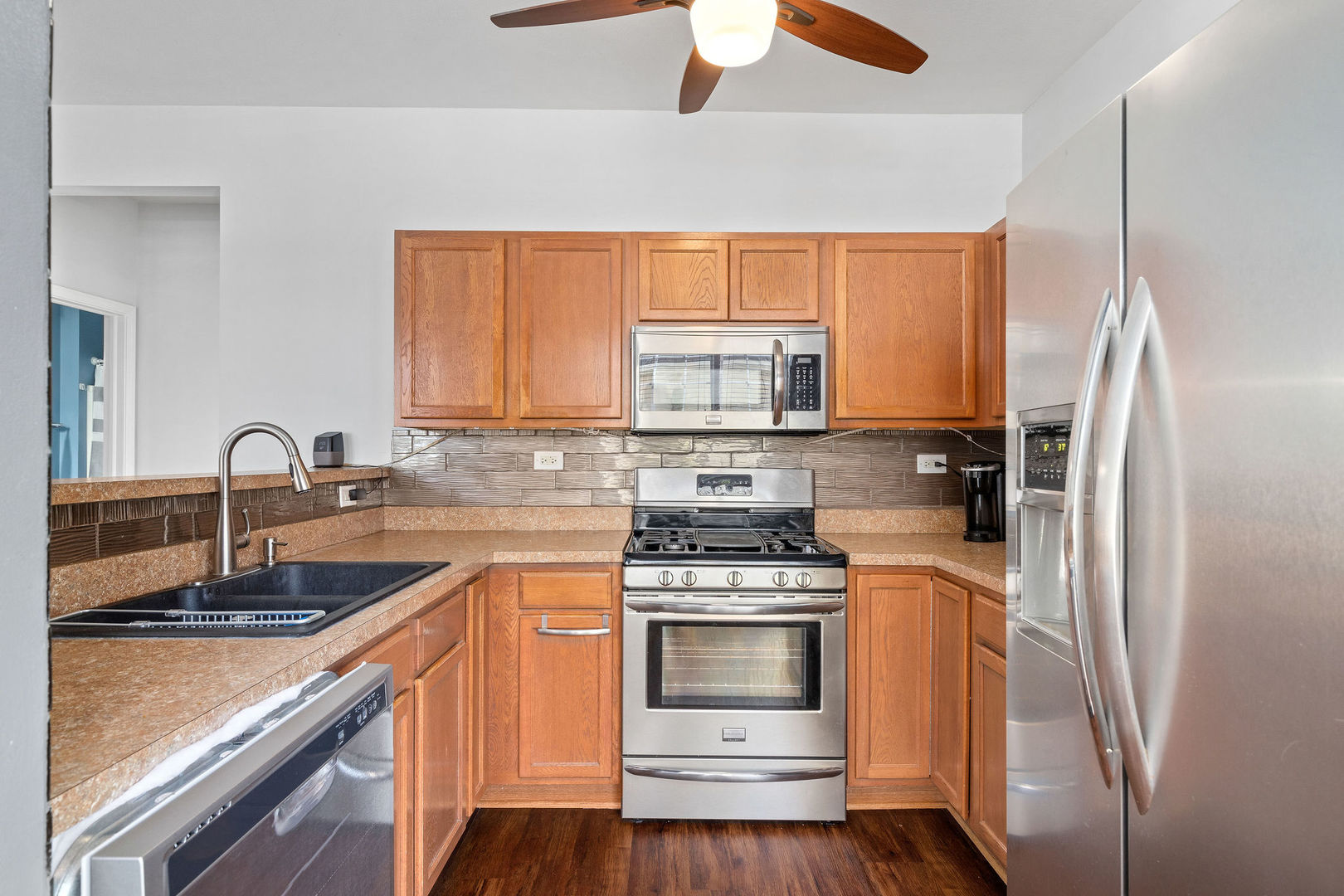 4486 Timber Ridge Court, Unit 4486 Joliet, IL 60431 - Photo 5 of 22 a kitchen with a sink stove and refrigerator