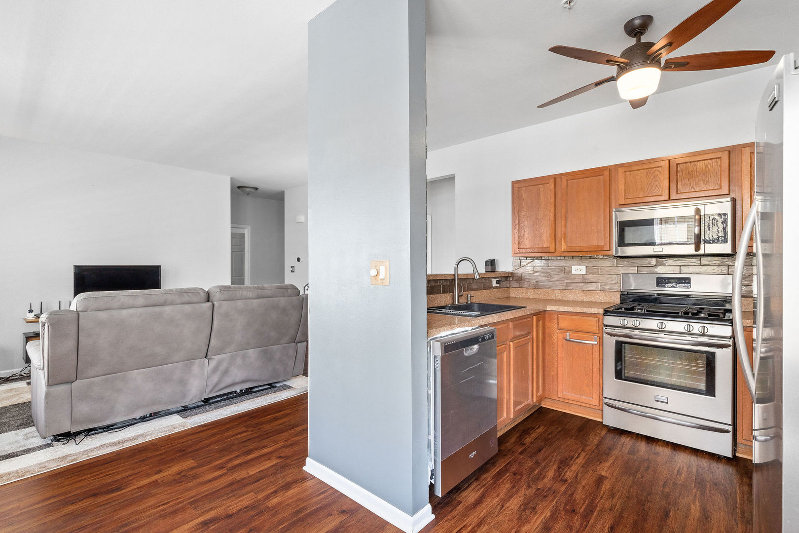 4486 Timber Ridge Court, Unit 4486 Joliet, IL 60431 - Photo 6 of 22 a kitchen with stainless steel appliances granite countertop a stove a sink and a refrigerator