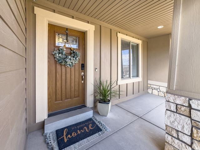 7280 Point Lookout Road Eagle Mountain, UT 84005 - Photo 26 of 26 Property entrance with a porch and stone siding